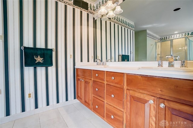 bathroom with double vanity, a stall shower, a sink, and tile patterned floors