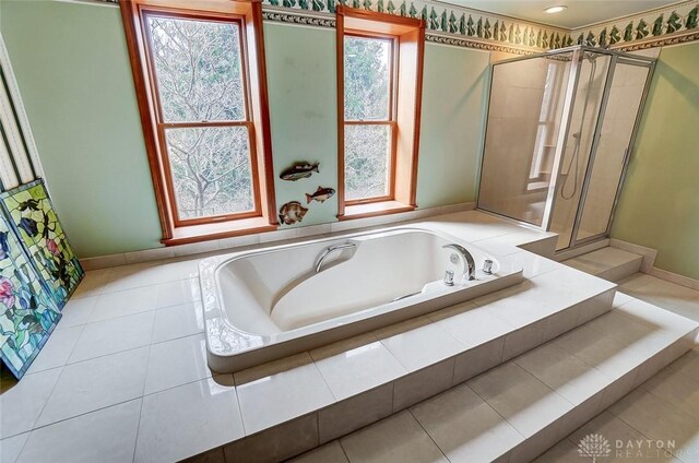6485 Munger Rd, Dayton, OH 45459 - bathroom featuring a garden tub, a shower stall, and baseboards