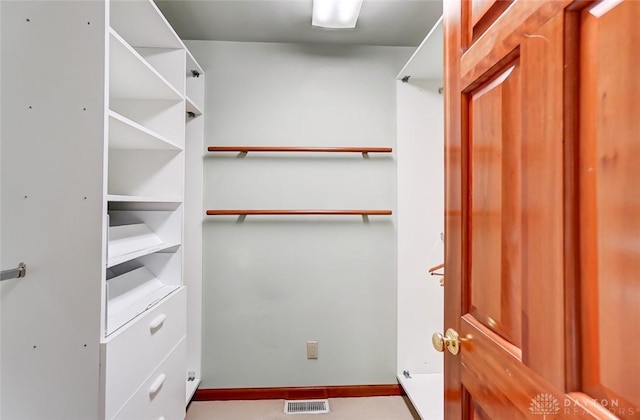 spacious closet featuring visible vents