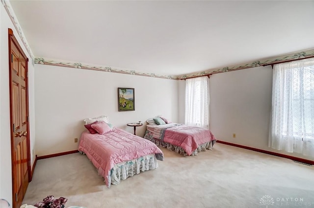 carpeted bedroom featuring visible vents and baseboards