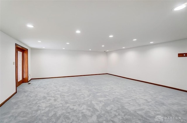 basement featuring baseboards, carpet flooring, and recessed lighting