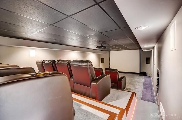 home theater featuring a paneled ceiling and baseboards