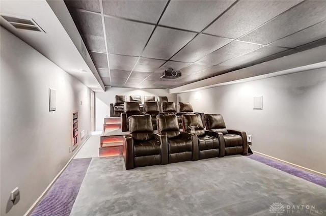 home theater room featuring carpet, baseboards, visible vents, and a drop ceiling