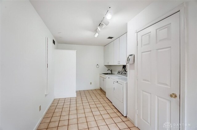 6485 Munger Rd, Dayton, OH 45459 - washroom featuring light tile patterned flooring, a sink, independent washer and dryer, cabinet space, and rail lighting