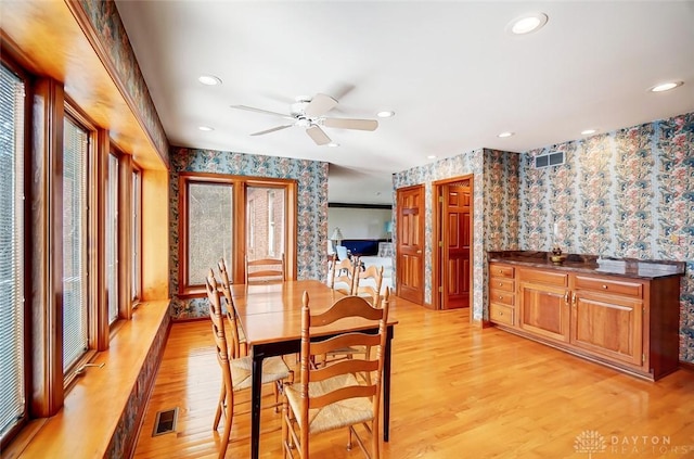 dining space with wallpapered walls, visible vents, light wood finished floors, and recessed lighting