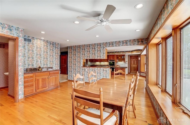 dining room featuring recessed lighting, light wood finished floors, and wallpapered walls