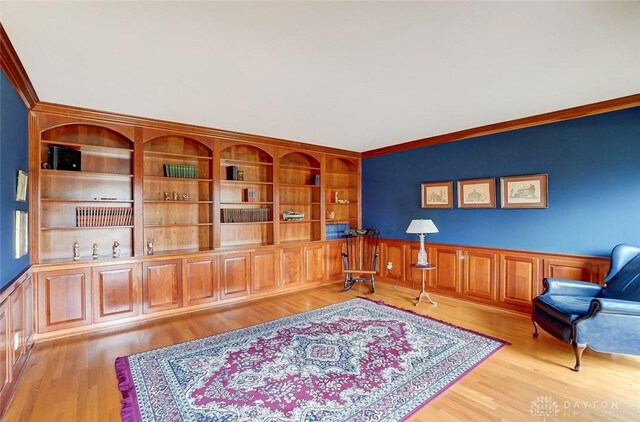 6485 Munger Rd, Dayton, OH 45459 - living area with a wainscoted wall, light wood-style flooring, and crown molding