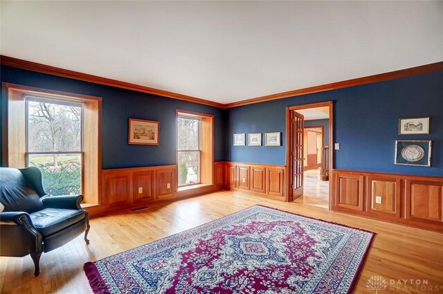 6485 Munger Rd, Dayton, OH 45459 - living area featuring a wainscoted wall, plenty of natural light, and wood finished floors