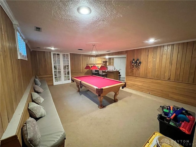 rec room featuring carpet floors, visible vents, a textured ceiling, and french doors