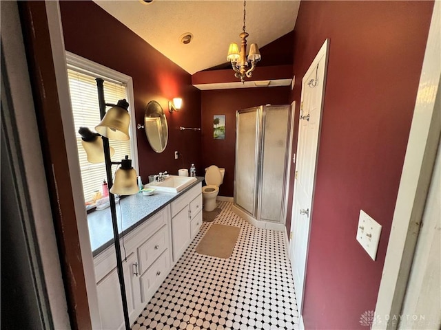 full bathroom featuring a notable chandelier, toilet, a stall shower, vaulted ceiling, and vanity