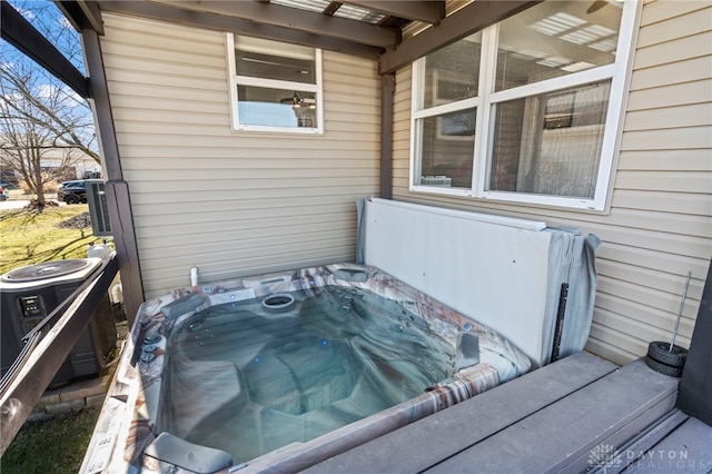 exterior space featuring a hot tub and central air condition unit