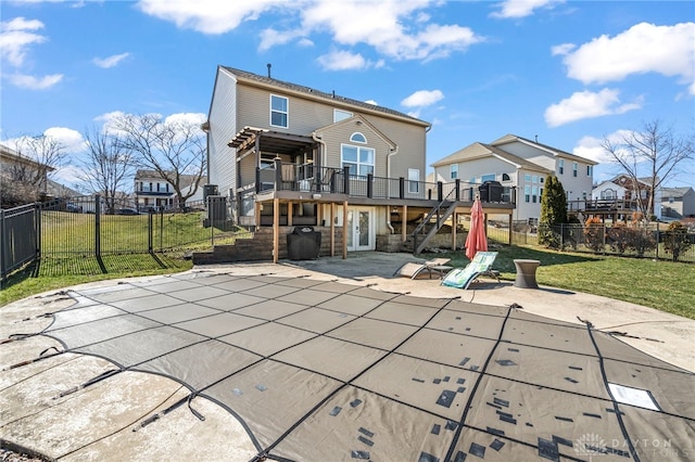 rear view of house with a wooden deck, a patio, a fenced backyard, stairs, and a yard