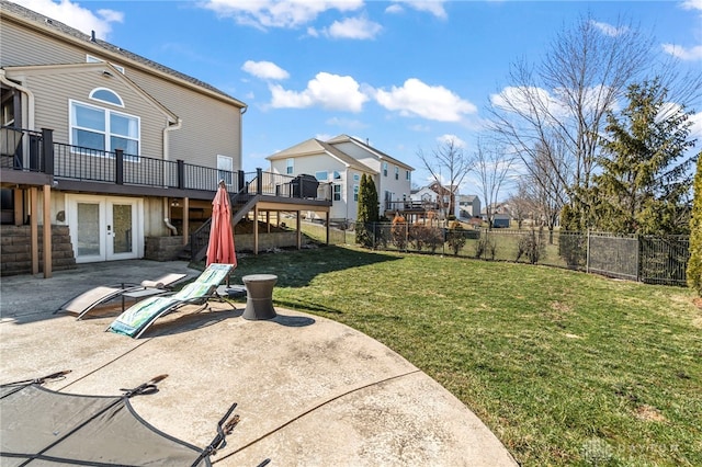 view of yard with french doors, a patio, a wooden deck, and fence