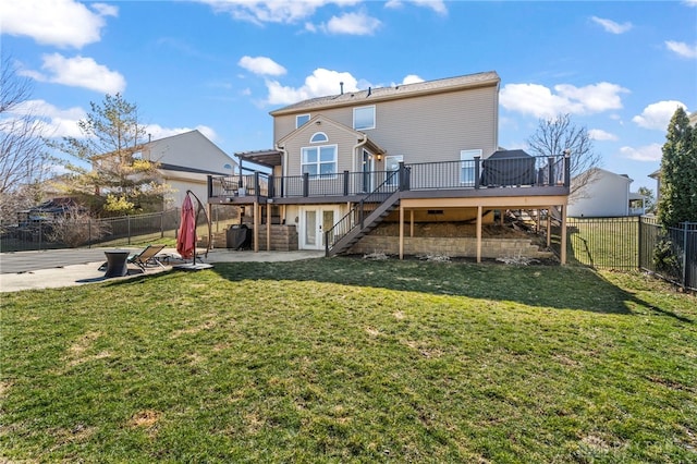 rear view of property with a lawn, a fenced backyard, stairs, a wooden deck, and a patio area