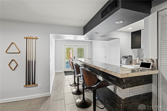 bar featuring recessed lighting, french doors, baseboards, and light tile patterned floors