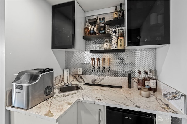 kitchen with wine cooler, a toaster, a sink, white cabinets, and tasteful backsplash