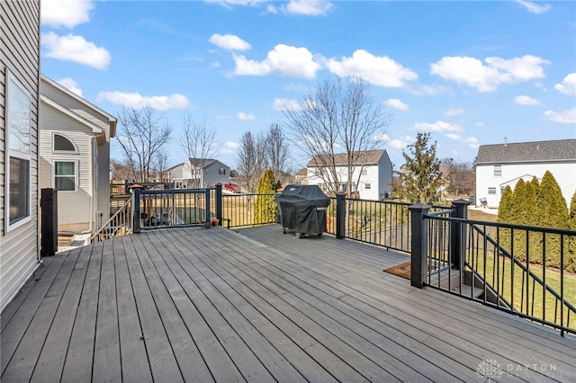 deck featuring area for grilling and a residential view