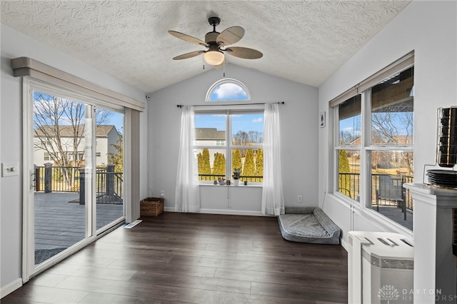 doorway featuring lofted ceiling, ceiling fan, a textured ceiling, and wood finished floors