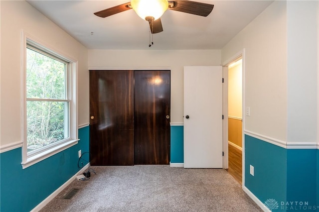 unfurnished bedroom featuring a closet, visible vents, baseboards, and carpet flooring