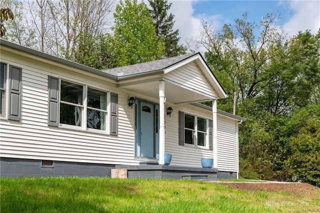 view of front of property with roof with shingles and crawl space