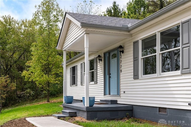 doorway to property featuring roof with shingles and crawl space