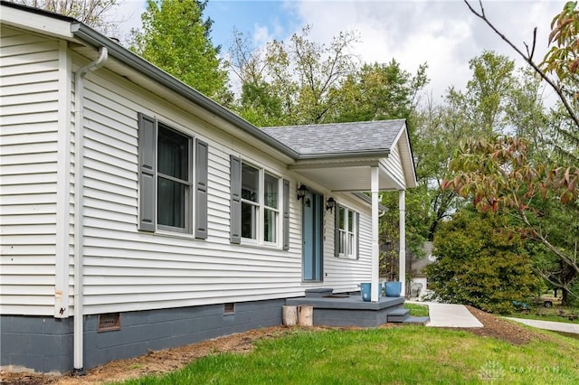 view of property exterior featuring crawl space, a shingled roof, and a yard