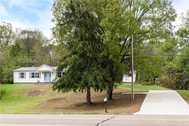 view of front of house with driveway, crawl space, and a front yard