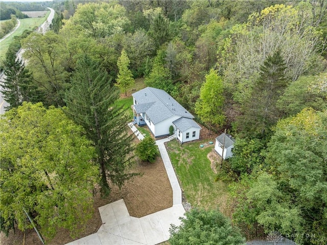 birds eye view of property with a wooded view