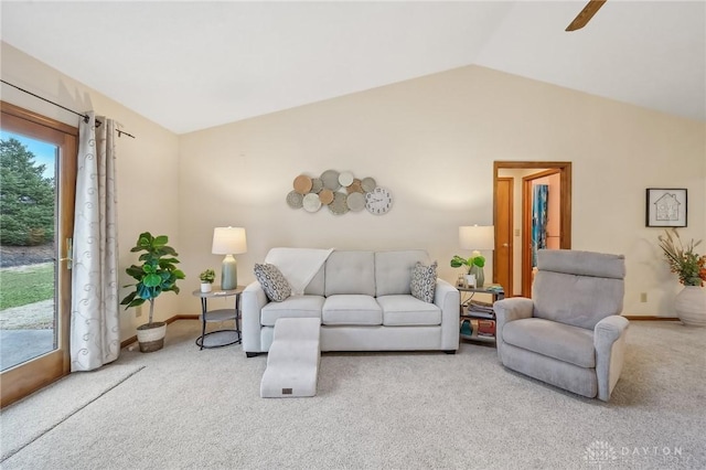 living area with lofted ceiling, baseboards, and carpet