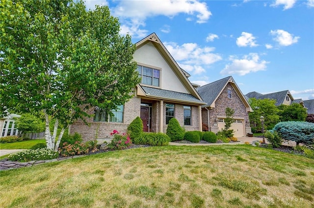 view of front of property with an attached garage, brick siding, stucco siding, and a front yard