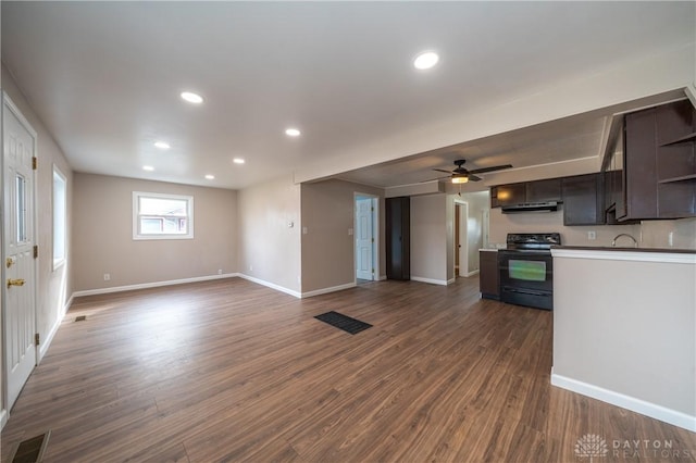 kitchen featuring black electric range, baseboards, visible vents, and dark wood-type flooring