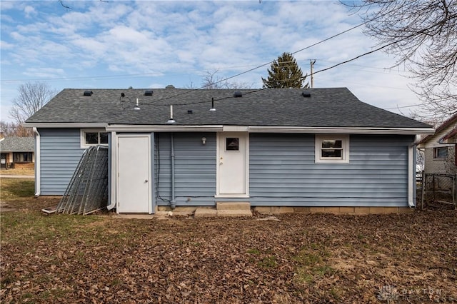 back of property featuring a shingled roof