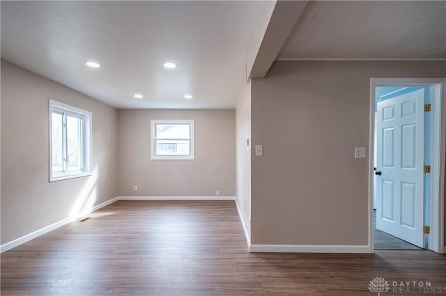 spare room with visible vents, baseboards, dark wood-style flooring, and recessed lighting