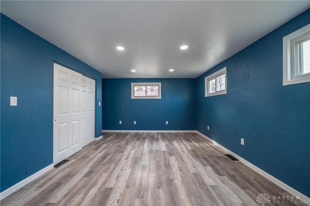 interior space with recessed lighting, wood finished floors, visible vents, and baseboards