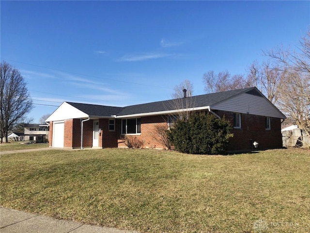 single story home with brick siding, a garage, and a front lawn