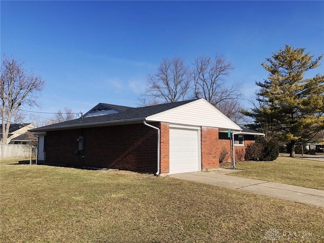 view of side of home with brick siding, driveway, a garage, and a yard