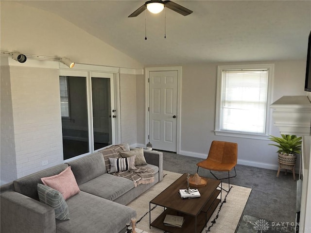 carpeted living area featuring lofted ceiling, a ceiling fan, and baseboards