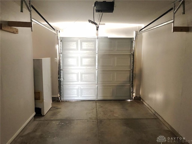 garage featuring baseboards and a garage door opener