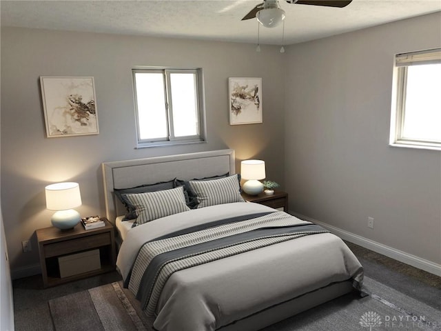 carpeted bedroom with a textured ceiling, a ceiling fan, and baseboards