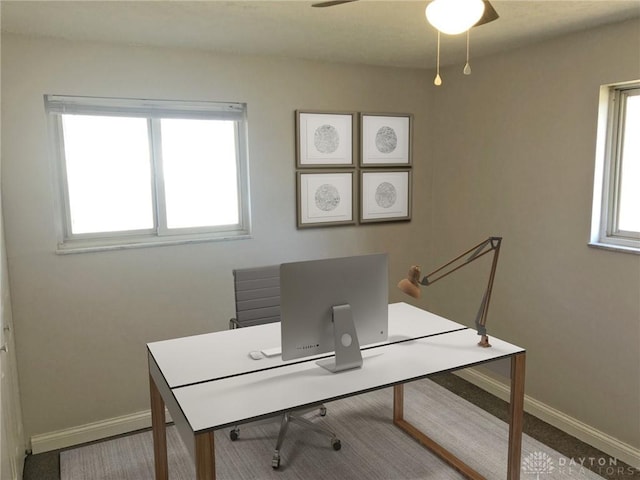 office area featuring a ceiling fan and baseboards