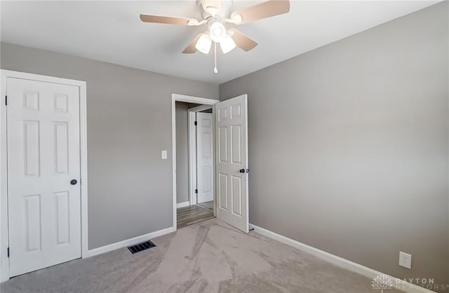 unfurnished bedroom with visible vents, a ceiling fan, and baseboards