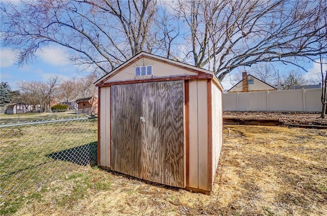 view of shed featuring fence