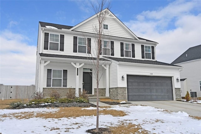 view of front facade featuring an attached garage, central AC, stone siding, and driveway