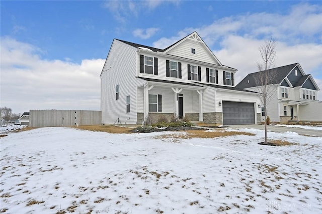 view of front of property with a garage, covered porch, stone siding, and fence