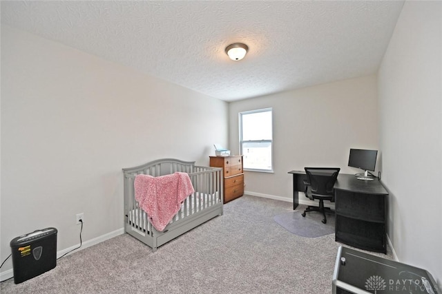 bedroom featuring a textured ceiling, carpet floors, and baseboards