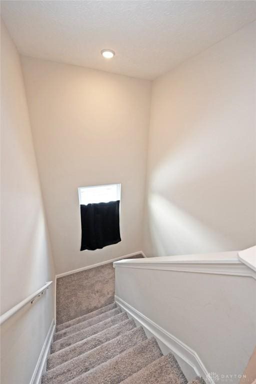 staircase featuring carpet, baseboards, and recessed lighting