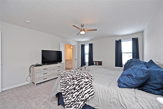 bedroom featuring a textured ceiling, carpet, a ceiling fan, and baseboards