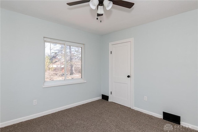 carpeted empty room featuring a ceiling fan and baseboards