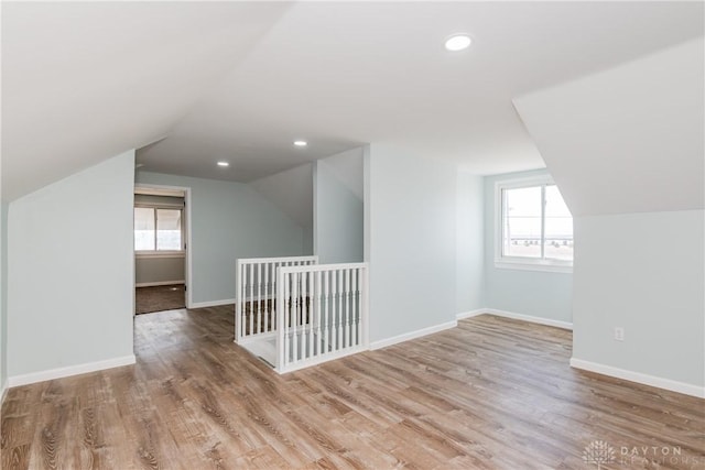 bonus room with a healthy amount of sunlight, baseboards, wood finished floors, and recessed lighting