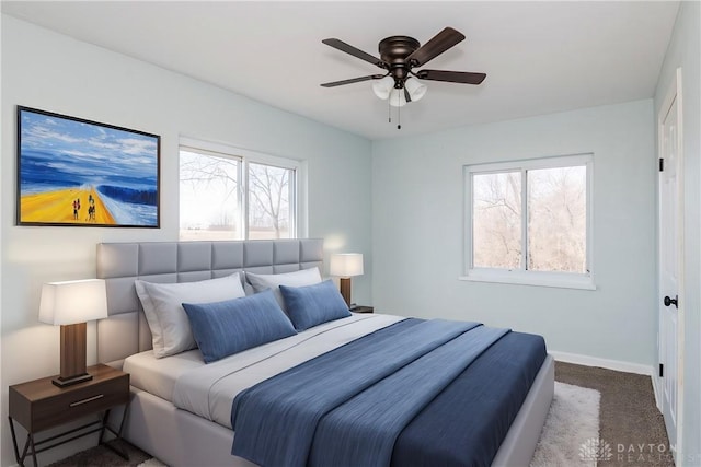 bedroom with carpet floors, baseboards, and a ceiling fan